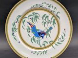 a close up of a plate with a bird painted on it
