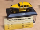 un taxi jaune et noir exposé dans une vitrine
