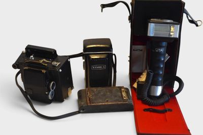 two old cameras and an old camera next to each other