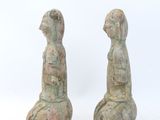 pair of ancient stone figurines of a woman and a man
