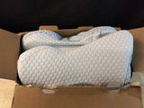 a box with a pillow inside of it on a table