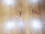 a close up of a wooden table with a knife on it