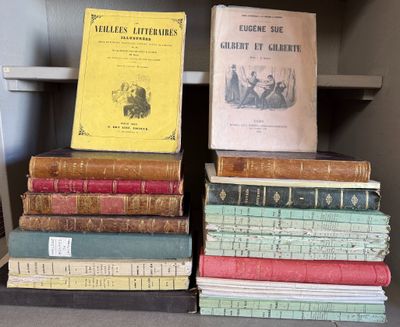 several old books are stacked on a shelf in a library