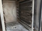 an open oven that is sitting on the floor