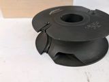 a spool of black plastic on a white table