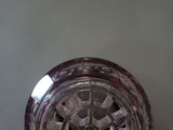 a glass clock that is sitting on a table