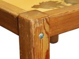 a close up of a wooden table with a painting on it
