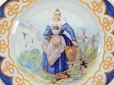 a blue and white plate with a picture of a woman