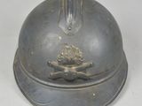a small metal bell with a flower on it