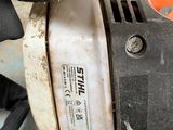 a close up of a person ' s hand holding an electric sander