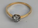 a close up of a diamond ring on a white surface