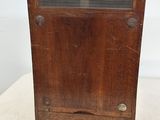 an old wooden radio sitting on top of a white table
