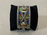 a close up of a bracelet on a black velvet case