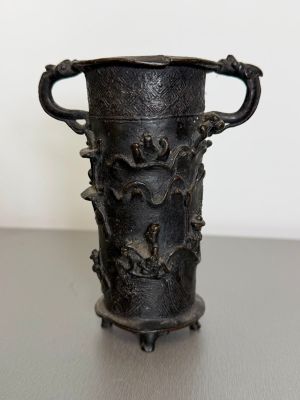 a black vase sitting on top of a table