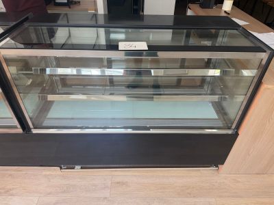 a glass display case with a lot of food inside of it