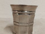 a silver cup that is sitting on a table