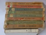 several old books stacked on top of each other on a table