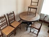 four chairs and a table in the corner of a room