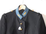 an image of a black jacket with a blue collar and gold buttons