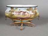 a large bowl with a painting on it on a stand