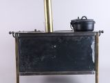 a small stove with a pot on top of it