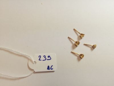 three screws and a tag on a white surface