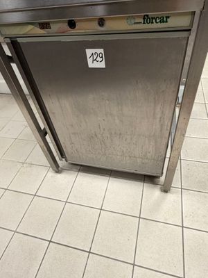 a stainless steel oven sitting on the floor in a kitchen