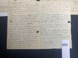 two old papers with writing on them sitting on top of a table