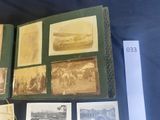 many old photos of people on display on a table