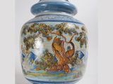 a blue and white vase with a painting on it