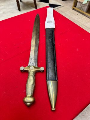 two knives are sitting on a red cloth on a table