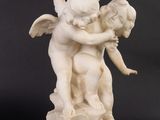statue of a boy and a girl hugging each other on a marble base