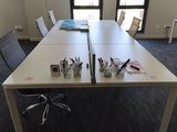 a long table with a bunch of pens and pencils on it