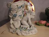 a figurine on a table with a mirror in the background