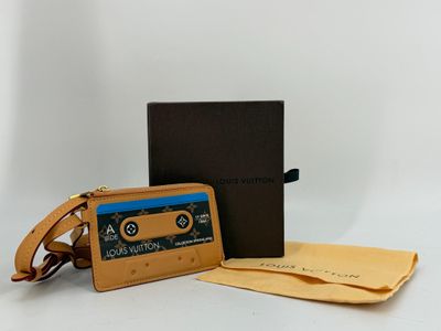 an image of a wallet with a cassette on it next to a box