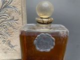 a bottle of perfume sitting on a table next to a box