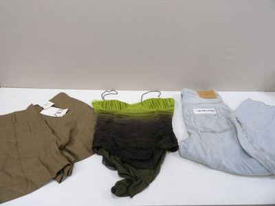 three pairs of men ' s pants are on a white table