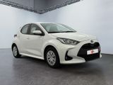 a white toyota yaris parked in a garage