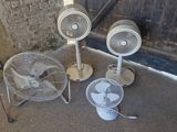 three fans sitting on the floor next to each other