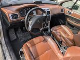 dashboard of a car with brown leather seats and dashboard controls