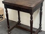 a small table with a wooden top on the floor