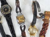 several different types of watches are lined up on a white surface