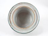 a close up of a vase on a white surface
