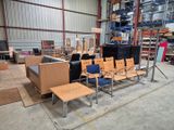 many chairs and tables in a large warehouse area
