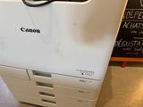 a canon printer sitting on top of a desk