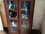 a wooden cabinet with glass doors in a room