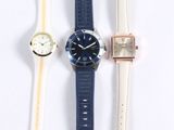 four different watches are lined up on a white surface