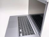 a silver laptop computer sitting on top of a white table