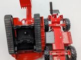 a toy tractor that is sitting on a white surface