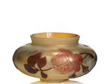 a yellow vase with a floral design on it